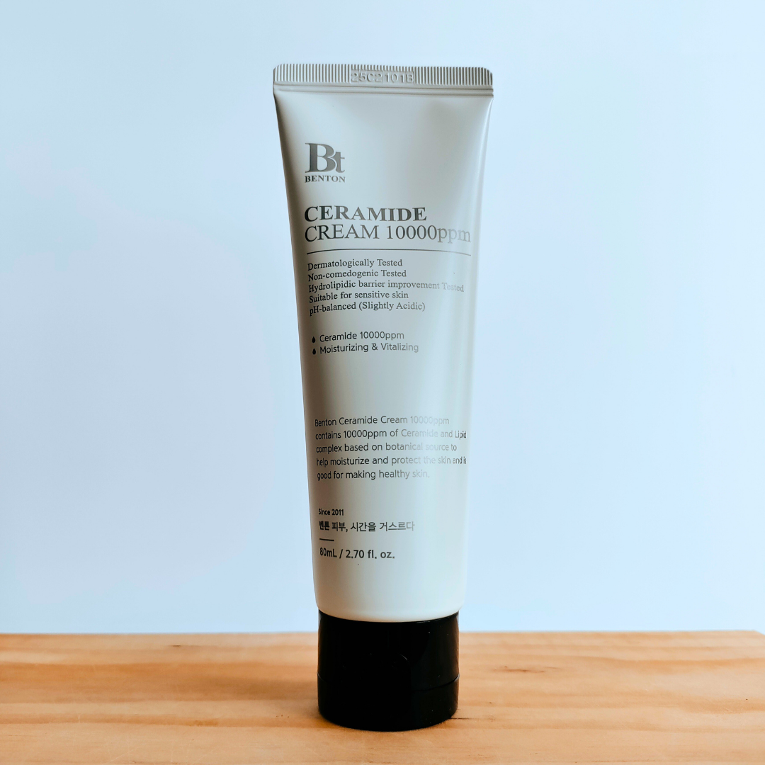 Tube of Ceramide Cream 1000ppm on a wooden surface with a light blue background