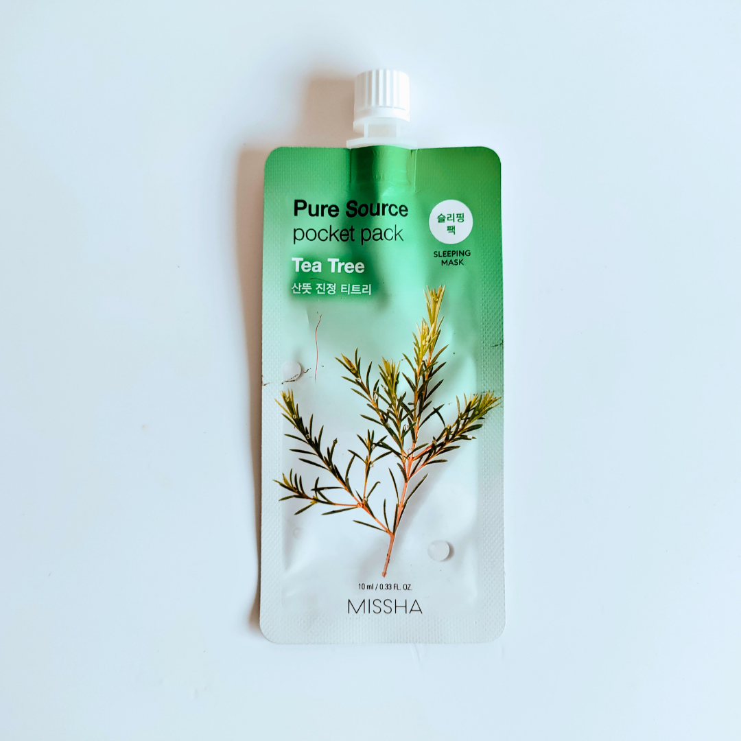 Green and white packaging of a tea tree pocket pack by Missha on a light blue background