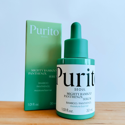 Purito Mighty Bamboo Panthenol Serum bottle and packaging on a wooden surface with a light blue background